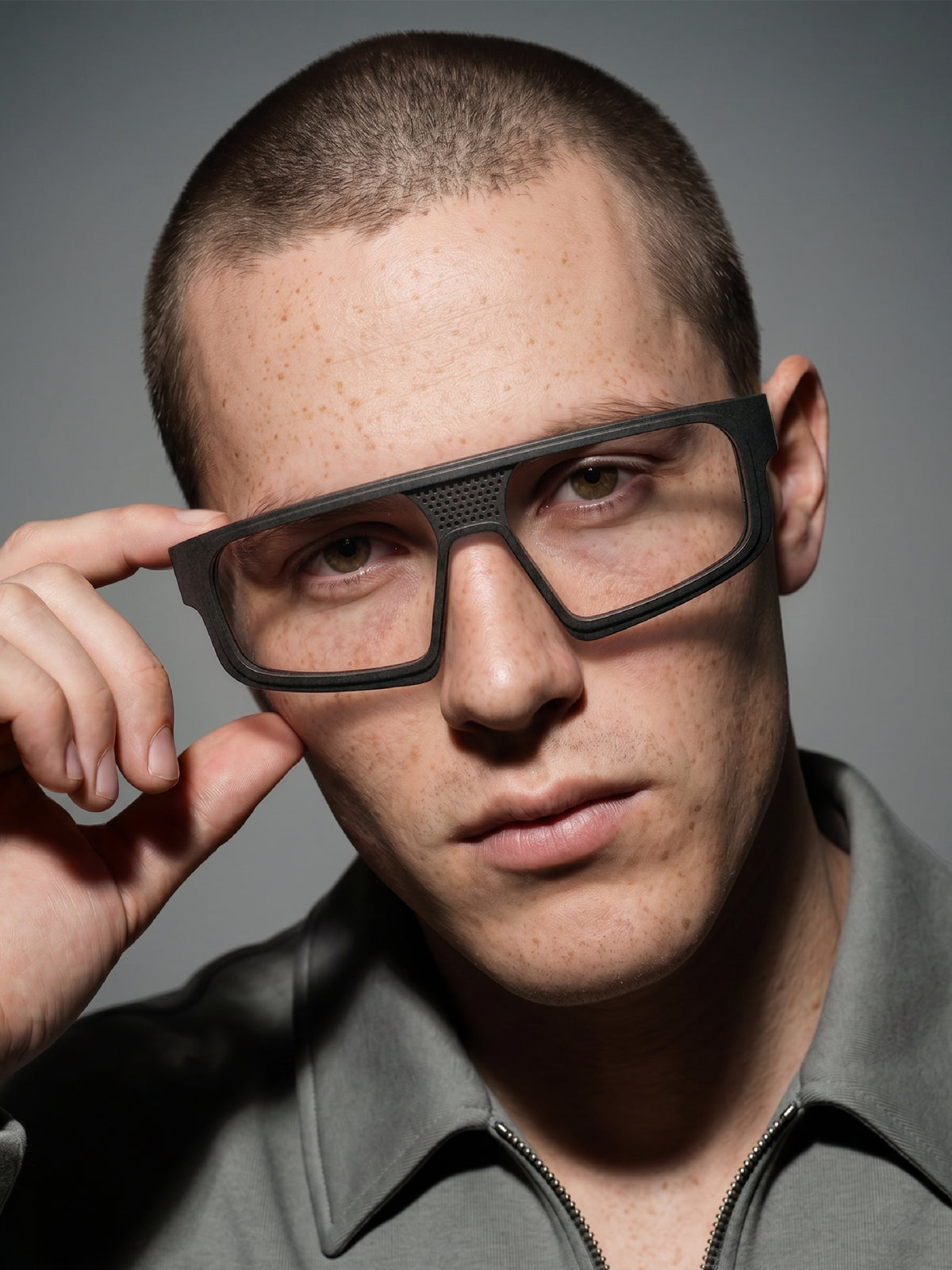 Close-up of Blynq Kyro rectangular glasses in Black worn by a model