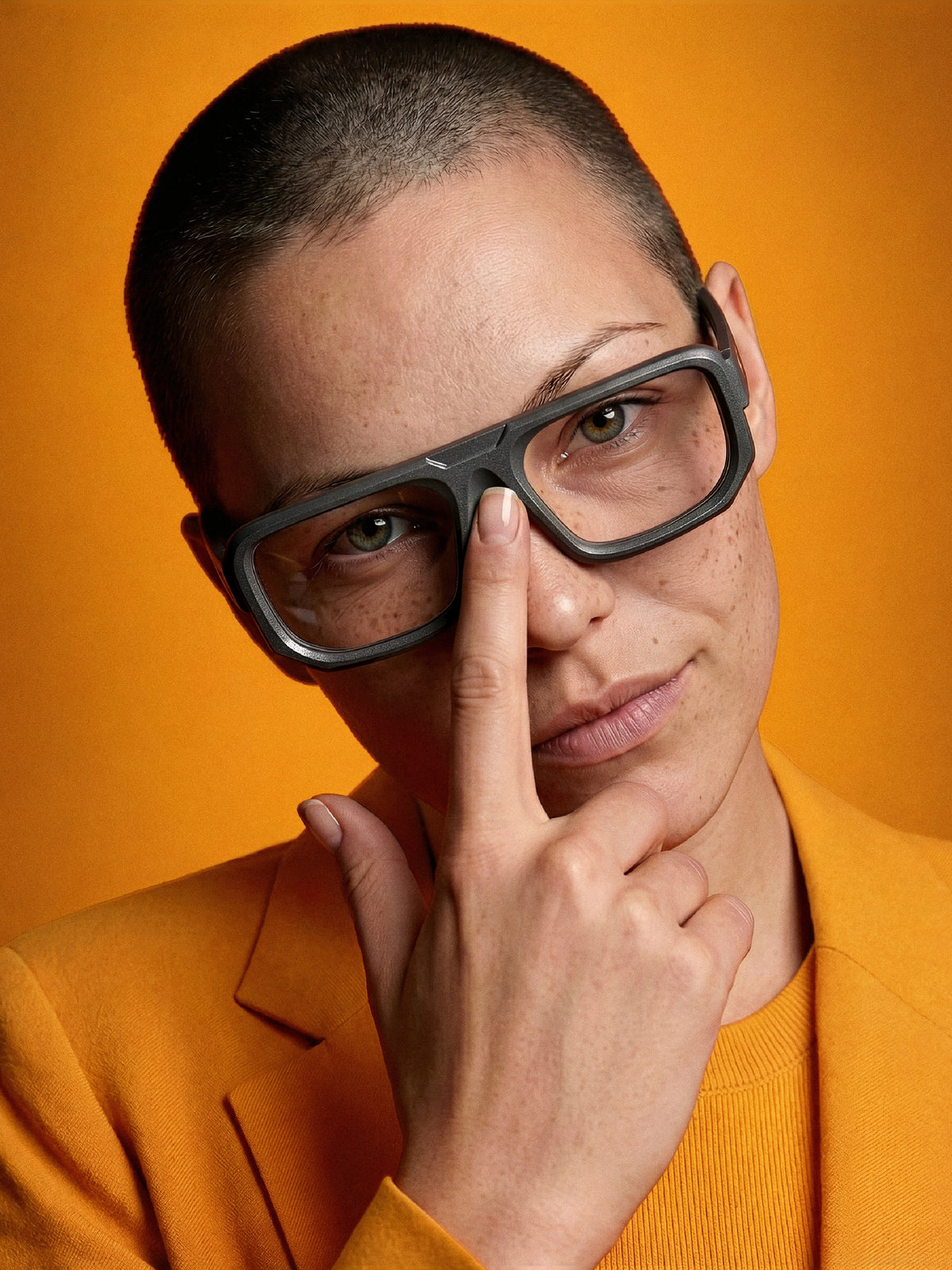 Close-up of Blynq Monark bold rectangular glasses in Graphite worn by a model