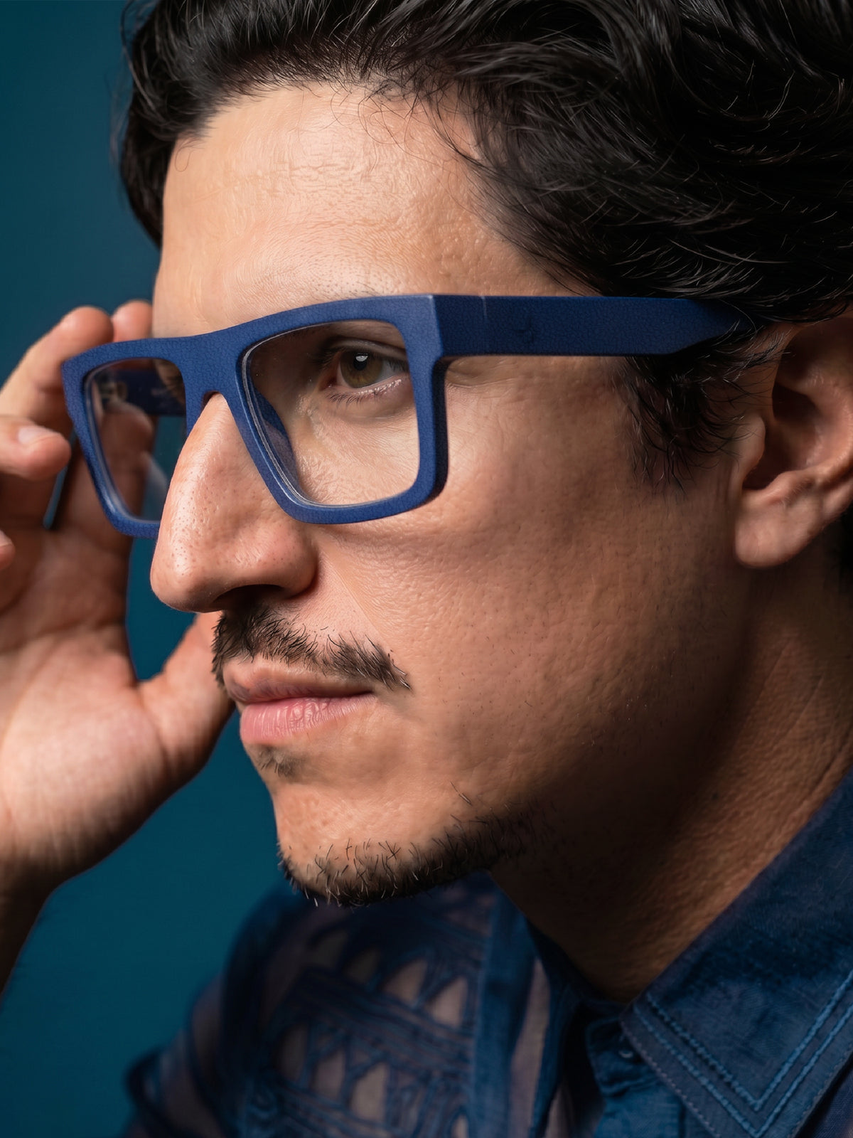 Close-up of Blynq Solo square glasses in Indigo worn by a model
